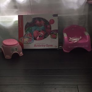 A baby activity gym  toddler and a stool